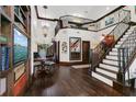 Spacious entry featuring hardwood floors, staircase with iron railings, and a stylish chandelier at 2388 Baronsmede Ct, Winter Garden, FL 34787