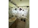 Cozy bathroom featuring shower and tub combo, vanity and neutral design elements at 2515 La Jolla Trl, Kissimmee, FL 34747