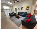 Bright living room featuring high ceilings, skylights, and cozy seating area at 2515 La Jolla Trl, Kissimmee, FL 34747