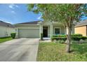 Beautiful single-Gathering home with a well-maintained lawn, complemented by lush green shrubbery at 264 Milestone Dr, Haines City, FL 33844