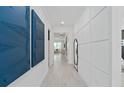 Bright hallway with modern design, white walls, and unique blue artwork, leading to the living area at 2674 Midsweet Ave, St Cloud, FL 34772