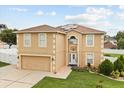 Two-story home with two-car garage, solar panels and landscaped front yard at 2725 White Magnolia Loop, Clermont, FL 34711