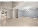 Spacious living room features tile flooring, neutral colors, and decorative lighting at 2725 White Magnolia Loop, Clermont, FL 34711