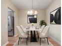 Inviting dining area with a modern table and chairs, stylish light fixture, and easy access to the kitchen at 2763 Metro Sevilla Dr # 103, Orlando, FL 32835
