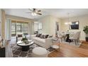 Cozy living room with a ceiling fan, modern furniture and sliding glass doors to the outdoor patio at 2763 Metro Sevilla Dr # 103, Orlando, FL 32835
