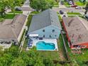 Aerial view of a home with a private backyard pool, patio, and fenced yard at 38 Jett Loop, Apopka, FL 32712