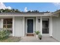 Inviting front entrance with a navy door, house number and decorative potted plants at 4217 Ilene Ct, Orlando, FL 32806