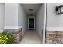 Welcoming front entryway featuring stone accents and a covered porch at 4564 Orchard Grove Rd, St Cloud, FL 34772