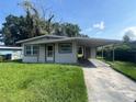 Cozy single-story home featuring a carport and a well-maintained front yard and walkway at 4631 America St, Orlando, FL 32811