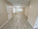 Expansive living room boasting tile floors, neutral walls and bright natural light from large windows at 4631 America St, Orlando, FL 32811