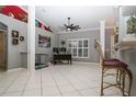 Open living space with tile flooring, natural light from large windows, and a built-in bar area at 6011 Country Walk Ln, Winter Haven, FL 33880