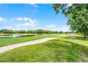 Scenic golf course view with manicured green fairways, a sand trap, and a tranquil pond at 6301 Parson Brown Dr, Orlando, FL 32819