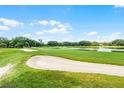 Picturesque golf course featuring green fairways, sand traps, and a water hazard at 6301 Parson Brown Dr, Orlando, FL 32819