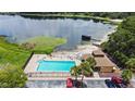 Community pool overlooking a lake with beach access, perfect for relaxation and recreation at 750 Olympic Cir # D1, Ocoee, FL 34761