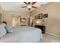 Cozy bedroom features a ceiling fan, neutral paint, and well-placed art at 901 Grovesmere Loop, Ocoee, FL 34761