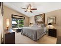 Comfortable bedroom with ceiling fan, neutral paint, and natural light from the window at 901 Grovesmere Loop, Ocoee, FL 34761