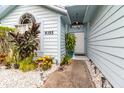 Inviting front entrance with decorative landscaping and a light-colored exterior at 9355 Telfer Run, Orlando, FL 32817