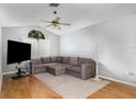 Comfortable living room with hardwood floors, a ceiling fan, and ample natural light at 9355 Telfer Run, Orlando, FL 32817