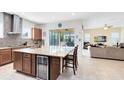Open kitchen with granite island, beverage cooler, and seamless flow to the living area at 9978 Mere Pkwy, Orlando, FL 32832