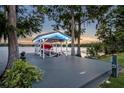 Covered boat house with a boat lift, offering easy lake access and scenic views at 339 Carolyn Dr, Oviedo, FL 32765