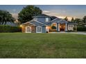 Charming two-story home with stone accents, a manicured lawn, and a welcoming entrance at 339 Carolyn Dr, Oviedo, FL 32765