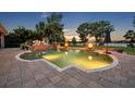Sparkling in-ground pool with a stone patio, fire bowls, and ample seating at 339 Carolyn Dr, Oviedo, FL 32765