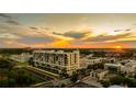 Scenic aerial view of building at sunset with city skyline, trains, and surrounding greenery at 111 E Monument Ave # 801, Kissimmee, FL 34741