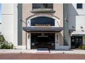 Elegant building entrance featuring detailed stonework, glass doors, and a welcoming design at 111 E Monument Ave # 801, Kissimmee, FL 34741