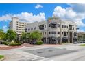 Well-maintained building exterior showcasing architectural details, awnings, and pedestrian access at 111 E Monument Ave # 801, Kissimmee, FL 34741