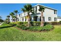 Attractive townhomes showcasing well-maintained landscaping and palm trees on a sunny street at 11802 Pulitzer Pl, Orlando, FL 32832