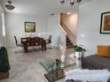 Inviting living area with tile floors, stylish furnishings, and a staircase at 11802 Pulitzer Pl, Orlando, FL 32832