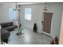 Cozy living room with a modern sofa, tile flooring, and natural light at 11802 Pulitzer Pl, Orlando, FL 32832