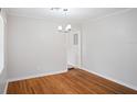 Bright dining area with hardwood floors, simple chandelier and neutral wall color at 1322 Morris Ave, Orlando, FL 32803