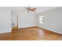 Spacious living room featuring hardwood floors, ceiling fan, and a sunlit window at 1322 Morris Ave, Orlando, FL 32803