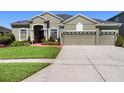 Well-maintained single-story home featuring mature landscaping and a three-car garage at 13478 Summer Rain Dr, Orlando, FL 32828
