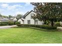Charming two-story home with lush landscaping and a well-manicured lawn at 1350 Lyndale Blvd, Winter Park, FL 32789
