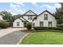 Charming two-story home with lush landscaping and a well-manicured lawn at 1350 Lyndale Blvd, Winter Park, FL 32789
