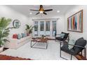 Inviting living room with a cozy seating arrangement, French doors leading to the pool, and a ceiling fan at 1350 Lyndale Blvd, Winter Park, FL 32789
