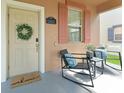 Cozy front porch with seating, stylish decor and a welcoming entrance at 14897 Evergreen Oak Loop, Winter Garden, FL 34787