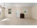 Spacious living room featuring tile flooring, ample natural light, and a welcoming entrance at 14897 Evergreen Oak Loop, Winter Garden, FL 34787