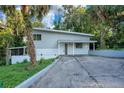 Charming two-story home featuring a modern design, complemented by lush tropical landscaping and a private driveway at 1630 Lakeview Ct, Eustis, FL 32726