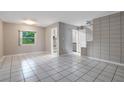 Open-concept living area with tile floors, offering access to the staircase and multiple rooms at 1630 Lakeview Ct, Eustis, FL 32726