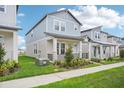 Attractive two-story home featuring a cozy porch and neatly manicured lawn at 16526 Silver Brook Way, Winter Garden, FL 34787