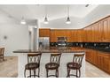 Modern kitchen with stainless steel appliances, a breakfast bar, and dark backsplash at 18920 Overton St, Orlando, FL 32833