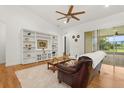 Bright living room with custom built-ins and a sliding glass door that leads to the lanai at 18920 Overton St, Orlando, FL 32833