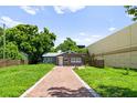 Attractive gray house with a brick walkway surrounded by green grass at 1921 Dartmouth Ave, Winter Park, FL 32789