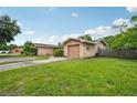 Home exterior with attached garage and driveway showcasing the landscaping around the property at 2020 Cocos Ct, Winter Park, FL 32792
