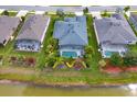 Home with a screened pool, back yard landscaping and view of a lake at 2440 Pawtucket Pass, Mount Dora, FL 32757