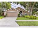 Inviting home exterior with a lush green lawn and neutral color scheme at 2737 Cahill Way, Lake Mary, FL 32746
