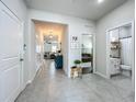 Bright hallway with tile flooring leading to bedrooms, bathrooms, and living areas, offering a spacious feel at 3849 Kimbolton Way, Sanford, FL 32773